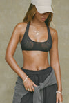 Front view of model posing in the sheer black mesh Scoop Neck Racerback Bra with a scoop neckline