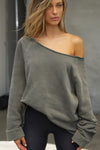 Front view of model posing in the oversized washed sage french terry Slouchy Pullover Sweatshirt with a wide, off-the-shoulder neckline and a JOAH BROWN logo patch on the right sleeve