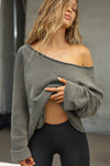 Front view of model posing in the oversized washed sage french terry Slouchy Pullover Sweatshirt with a wide, off-the-shoulder neckline and a JOAH BROWN logo patch on the right sleeve