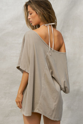 Back view of model posing in the oversized sage grey classic cotton Slouchy Tunic Tee with a wide scoop neckline that can be worn off the shoulder