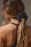 Back view of model wearing the soft and stretchy ink luxe knit Knit Scrunchie wrapped around her pony tail