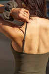 Close up back of model posing in the fitted and slightly cropped woodland flexrib Strappy Scoop Tank with a scoop neckline and adjustable straps. 