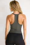 Back view of model posing in the fitted stretchy mineral flexrib V Neck Racerback Tank with a narrow racerback silhouette and thin straps