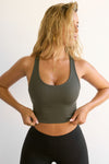 Front view of model posing in the fitted stretchy cropped mineral flexrib Varsity Tank Bra with a scoop neckline