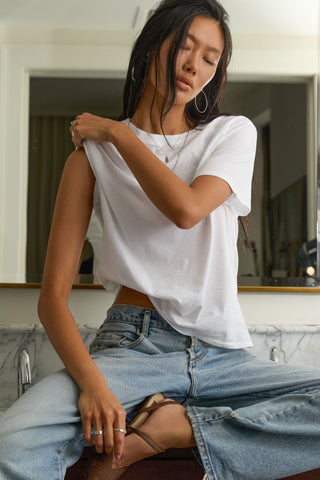 Front view of model posing in the optic white classic cotton Vintage Tee with a crew neckline and relaxed silhouette