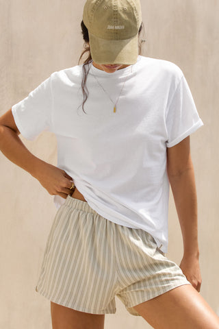 Front view of model posing in the optic white classic cotton Vintage Tee with a crew neckline and relaxed silhouette