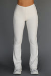 Front view of model from the waist down posing in the mid-rise fitted natural luxe knit Fitted Mini Flare Pant with a slightly flare leg