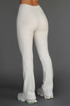Back view of model from the waist down posing in the mid-rise fitted natural luxe knit Fitted Mini Flare Pant with a slightly flare leg