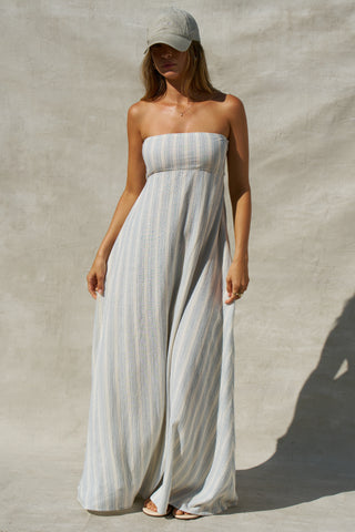 Front view of model posing in the relaxed-fit lightweight natural white and blue stripe gauze Essential Maxi Dress with a straight neckline, fitted bodice and removable adjustable straps 