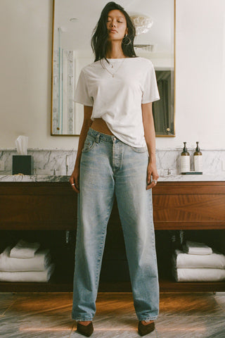 Full body front view of model posing in the optic white classic cotton Vintage Tee with a crew neckline and relaxed silhouette