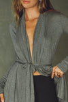 Close up front view of model posing in the light weight long sleeve ash grey modal Tie Cardigan with adjustable ties at the waist