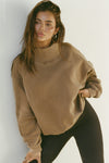 Front view of model posing in the comfortable cocoa french terry Turtleneck Sweatshirt pullover with a side split in the collar and a slightly oversized fit