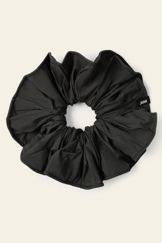Flat lay view of the oversized jet Nylon Scrunchie with a voluminous silhouette.