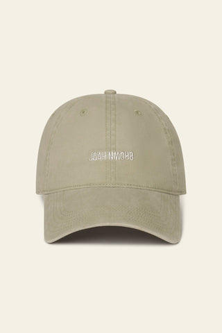 Flat lay front view of the six-panel desert Official Cap with a curved brim and an embroidered upside down Joah Brown logo on the front