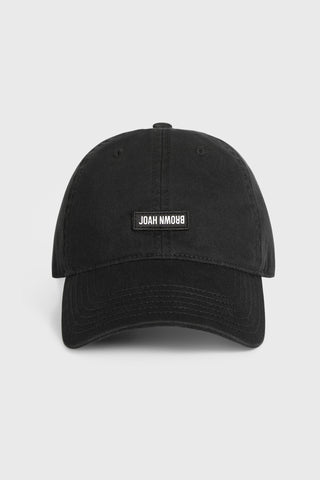 Flat lay fornt view of the six-panel black Signature Cap with a curved brim and a custom upside down Joah Brown logo patch on the front