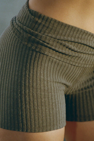Close up detail side view of model from the waist down posing in the fitted, soft army luxe knit Foldover Short with a fold-over waistband that can be worn high, mid or low rise