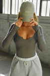 Front view of model posing in the fitted mineral rib Henley Long Sleeve with a notch in the scoop neckline