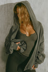 Front view of model posing in the fitted mineral rib Henley Long Sleeve with a notch in the scoop neckline