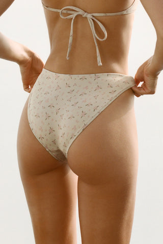 Close up back view of model from the waist down posing in the antique floral High-Waisted Bikini Bottom with a full back coverage bottom and high-cut legs