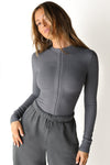 Front view of model wearing the form fitting smoke flexrib Invisible Zip Long Sleeve top with a 3/4 front invisible zipper and a crew neckline