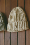 Front view of the soft and warm oat Knit Beanie that has a removable custom JOAH BROWN pin.