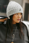 Front view of model posing in the soft and warm sterling Knit Beanie that has removable custom JOAH BROWN pin.