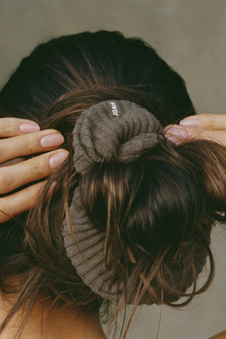 Close up detail back view of model wearing the soft and stretchy army luxe knit Knit Scrunchie wrapped around her pony tail