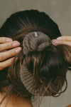 Close up detail back view of model wearing the soft and stretchy army luxe knit Knit Scrunchie wrapped around her pony tail