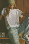 Front view of model posing in the relaxed fit white modal Boyfriend Tee with a crew neckline