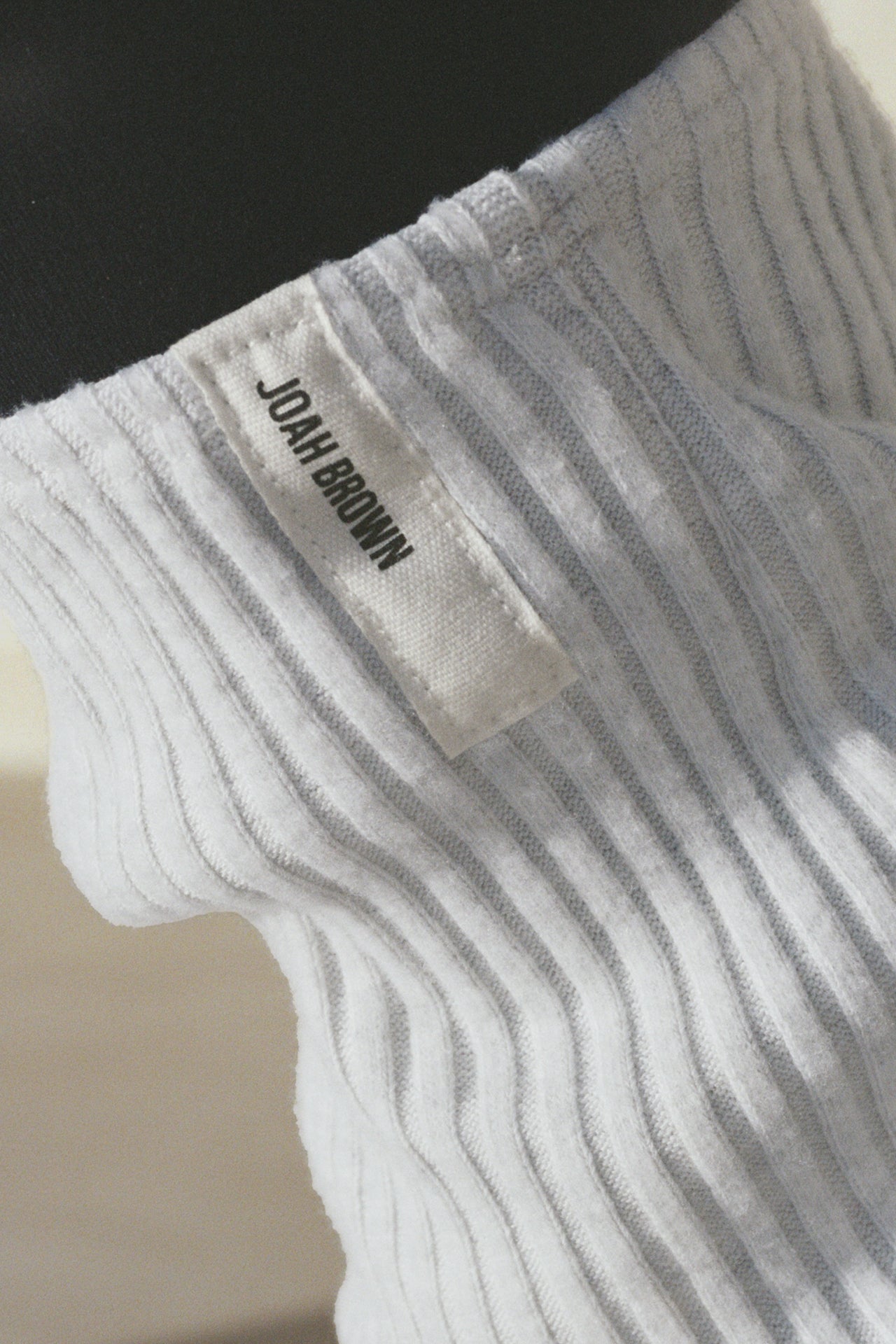 Close up detail side view of the slouchy, pull on pearl grey luxe knit Leg Warmers that can be worn pulled up on scrunched down