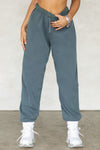 Front view of model from the waist down wearing the oversized loose fit evergreen french terry Oversized Jogger with an elastic waistband and ankle cuffs
