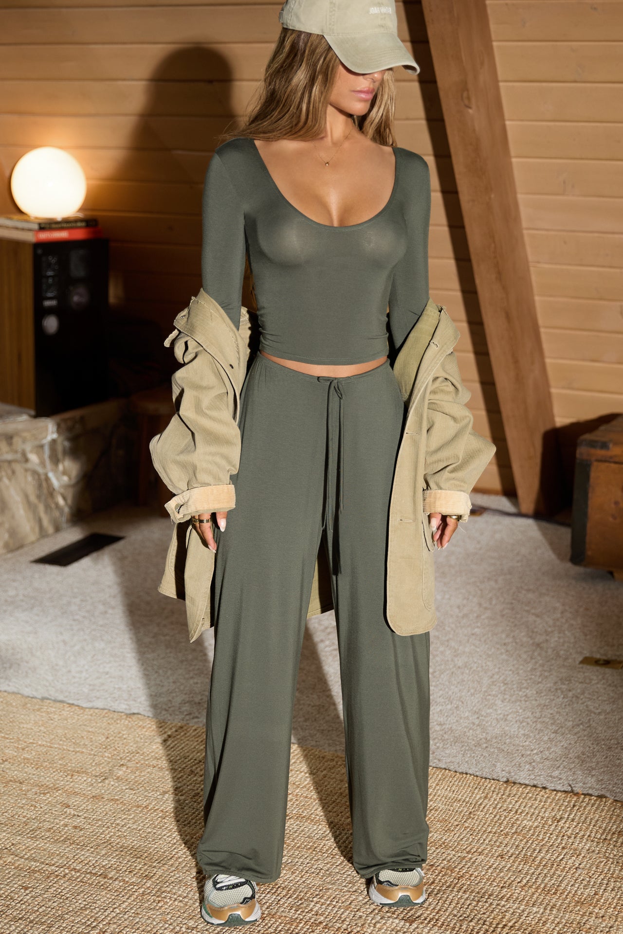 Full body front view of model posing in the relaxed fit spruce modal Relaxed Straight Leg Pant with a wide leg, elastic waistband, adjustable drawstring tie and subtle pleating at the sides.