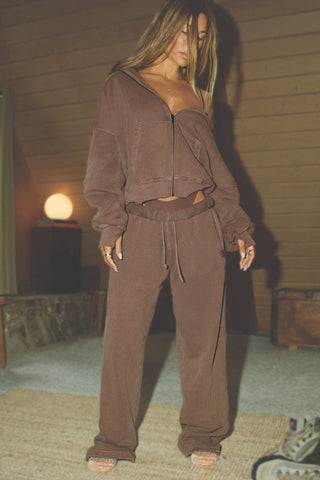 Full body front of model posing in the relaxed fit cedar french terry Oversized Straight Leg Jogger with an elastic waistband, hidden drawstring, pocket details. and adjustable cinching at the ankle cuffs