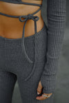 Close up front view of model from the waist down posing in the mid-rise fitted charcoal luxe knit Fitted Mini Flare Pant with a slightly flare leg
