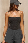 Front view of model posing in the semi-fitted charcoal washed rib Square Neck Cami with thin, wide-set straps and a clean, straight neckline.