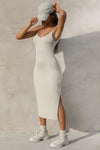 Full body side view of model posing the the midi length dune rib V Neck Dress with a semi-relaxed fit, v neckline, side slit and thin adjustable straps