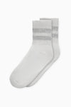 Flat lay view of the crew-style silver Mini Stripe Sock with ribbed cuffs