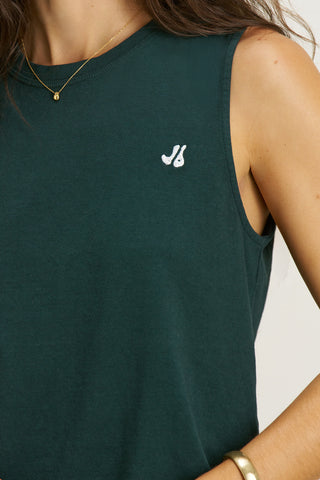 Close up detail front view model posing in the relaxed fit alpine cotton Muscle Tank with a crew neckline