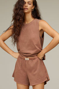 Front view model posing in the relaxed fit tobacco classic cotton Muscle Tank with a crew neckline