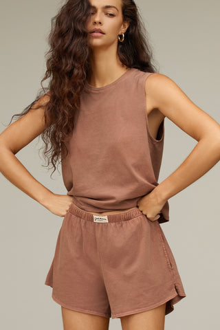 Front view model posing in the relaxed fit tobacco classic cotton Muscle Tank with a crew neckline