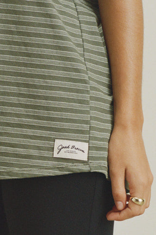 Close up detail front view of model posing in the oversized, lightweight forest stripe classic cotton Off-Duty Tee with a crew neckline and dropped shoulders