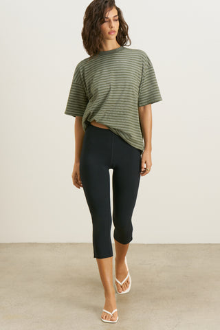 Full body front view of model posing in the oversized, lightweight forest stripe classic cotton Off-Duty Tee with a crew neckline and dropped shoulders