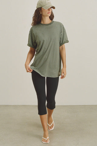 Full body front view of model posing in the oversized, lightweight forest stripe classic cotton Off-Duty Tee with a crew neckline and dropped shoulders