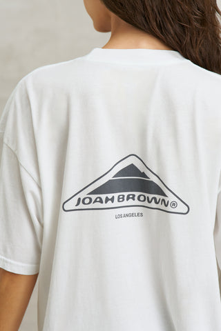Close up back view of model posing in the oversized, lightweight optic white classic cotton Off-Duty Tee with a crew neckline and dropped shoulders