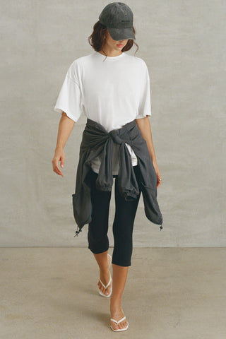 Full body front view of model posing in the oversized, lightweight optic white classic cotton Off-Duty Tee with a crew neckline and dropped shoulders