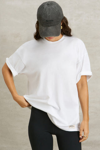 Front view of model posing in the oversized, lightweight optic white classic cotton Off-Duty Tee with a crew neckline and dropped shoulders