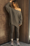 Full body front view of model posing in the relaxed fit army luxe knit Off Shoulder Tunic with a wide off-the-shoulder neckline and asymmetrical hem