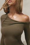 Close up detail front view of model posing in the fitted woodland rib Off Shoulder Twist Long Sleeve top asymmetrical neckline with a twist detail and off-shoulder design