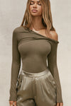 Front view of model posing in the fitted woodland rib Off Shoulder Twist Long Sleeve top asymmetrical neckline with a twist detail and off-shoulder design