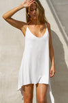 Front view of model posing in the flowy and relaxed white modal Open Back Slip Tank with and open back, adjustable straps and back button closures for a customizable fit.